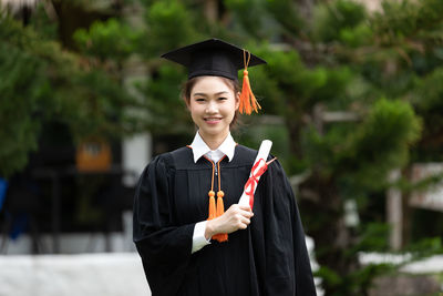 Portrait of woman holding certificate