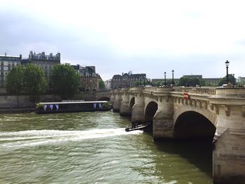 Bridge over river with buildings in background