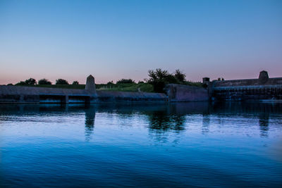 Calm blue sea with buildings in background