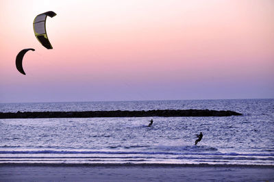 High angle view of people parasailing at beach