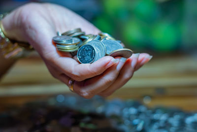 Close-up of hand holding coins