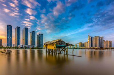 Scenic view of buildings against cloudy sky