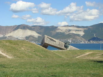 Scenic view of land and mountains against sky