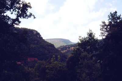 Scenic view of mountains against cloudy sky