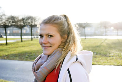 Portrait of smiling young woman against sky