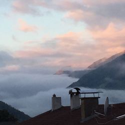 Scenic view of mountains against cloudy sky