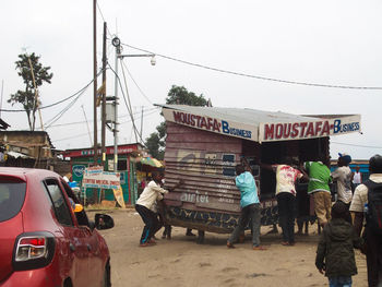 Rear view of people walking on street in city