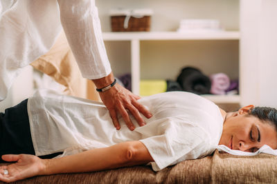 Therapist massaging womans back. woman getting shiatsu back massage.