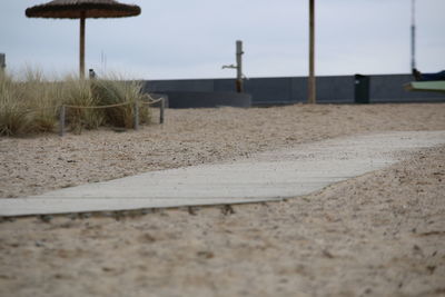 Surface level of sandy beach against sky