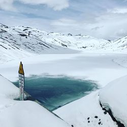 Scenic view of snow covered mountains against sky