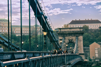 Chain bridge against buildings in city