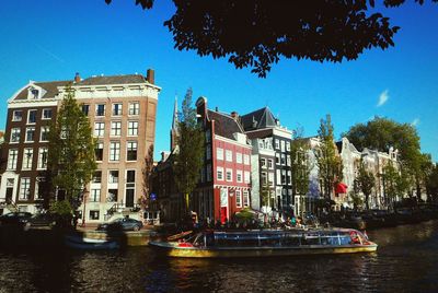 Boats in canal with buildings in background