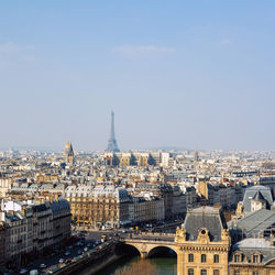 Distant view of eiffel tower against sky in city