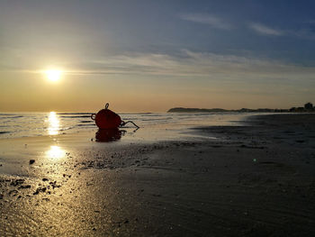 Beach against sky during sunset