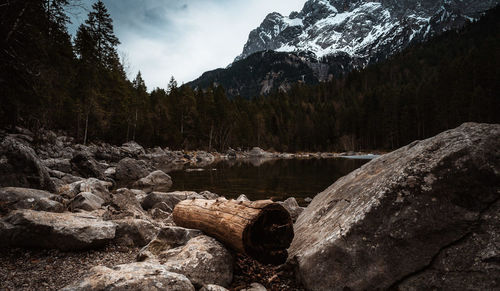 View of rocks in lake against sky