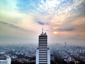 Cityscape against cloudy sky