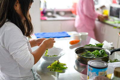 Midsection of woman preparing food in restaurant