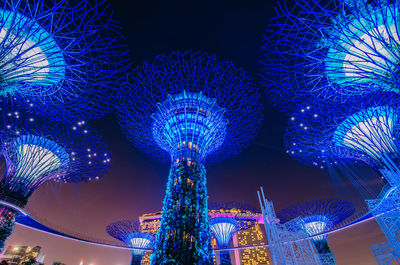 Low angle view of illuminated ferris wheel at night