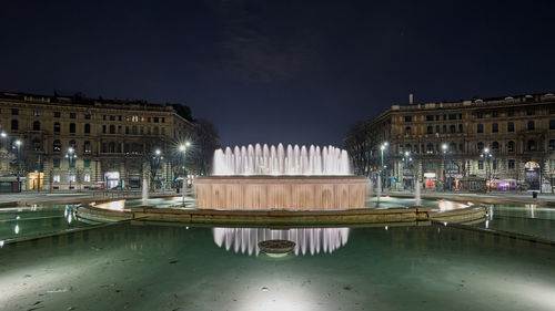 Reflection of illuminated buildings in water at night