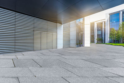 Empty footpath by building in city