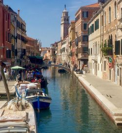 Boats in canal with buildings in background