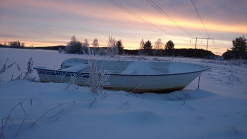 Scenic view of frozen lake against sky during sunset