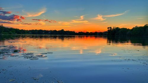 Scenic view of lake against sky during sunset