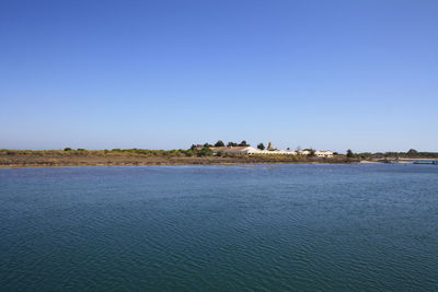 Scenic view of sea against clear blue sky