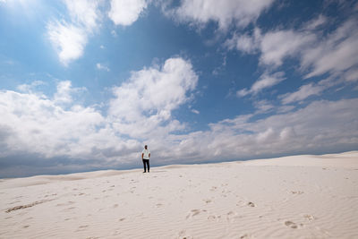 Full length of man standing on desert against sky