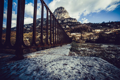 Bridge amidst trees against sky