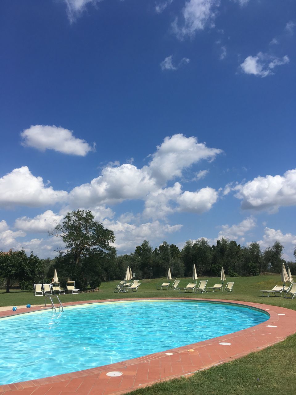 swimming pool, pool, sky, water, plant, nature, cloud - sky, tree, day, blue, outdoors, beauty in nature, no people, travel destinations, sunlight, sport, growth, turquoise colored