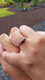 Close-up of hand holding ring