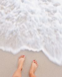 Low section of woman at beach