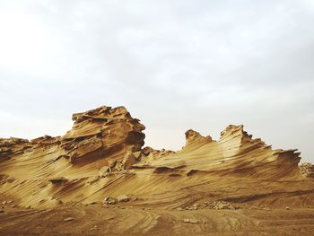 Rock formation on land against sky