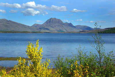 Scenic view of lake and mountains against sky