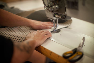 Midsection of man working on table