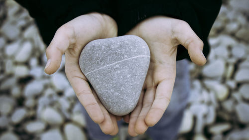 Close-up of human hands holding rock