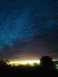 Low angle view of silhouette trees against sky at sunset