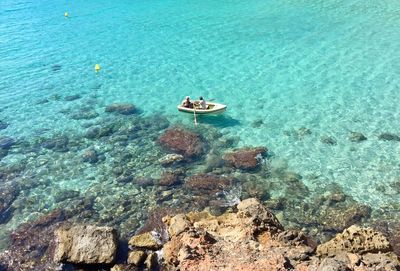 High angle view of two people kayaking in sea