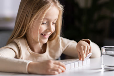Close-up of young woman using laptop at home