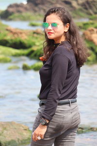 Portrait of smiling young woman drinking water