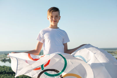 Portrait of boy wearing sunglasses against sky