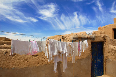 Clothes drying on clothesline against wall