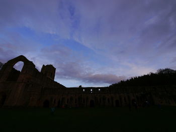 Low angle view of historical building against cloudy sky