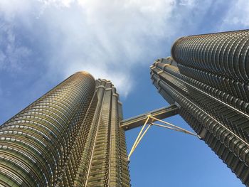 Low angle view of modern building against cloudy sky