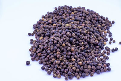 High angle view of berries on white background