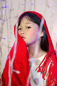 Portrait of girl by illuminated string light