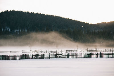 Scenic view of landscape against sky during winter