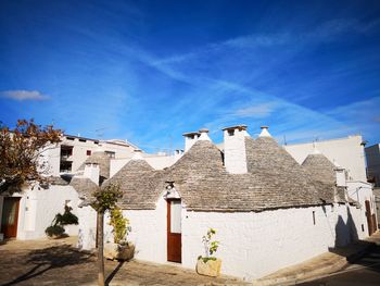 Old building in town against blue sky