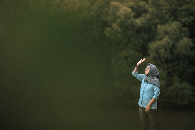 Rear view of woman standing at park